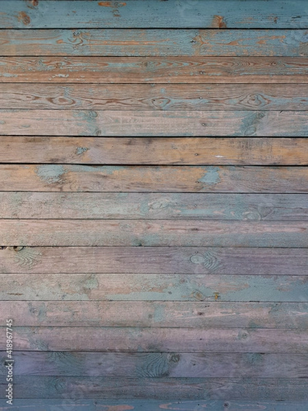Fototapeta Texture of old wooden planks arranged horizontally with faded blue paint. Without people. Old village house made of wooden planks, with peeling paint. As a background or desktop wallpaper. 