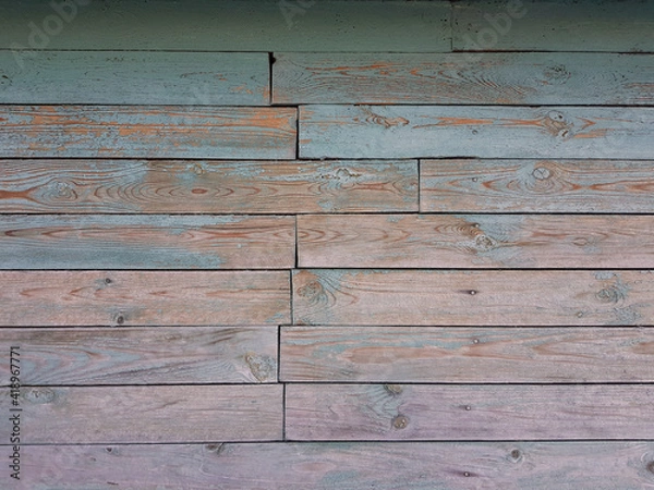 Fototapeta Texture of old wooden planks arranged horizontally with faded blue paint. Without people. Old village house made of wooden planks, with peeling paint. As a background or desktop wallpaper. 