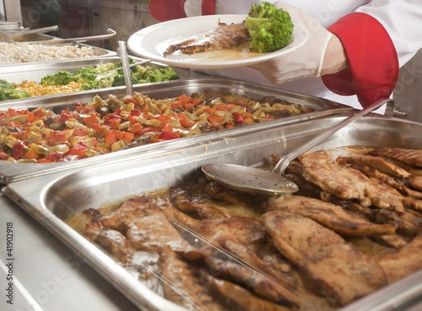 Obraz chef standing behind full lunch service station