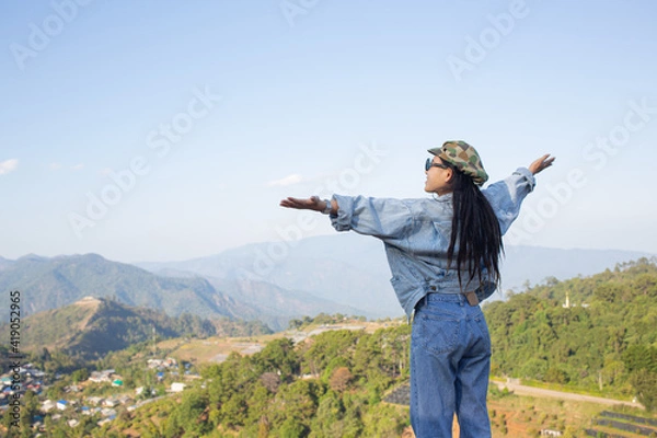 Obraz woman spread arms in the middle of a high trees nature forest