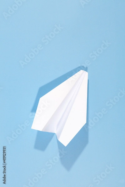 Obraz White paper airplane with shadow. Airplane on a blue background