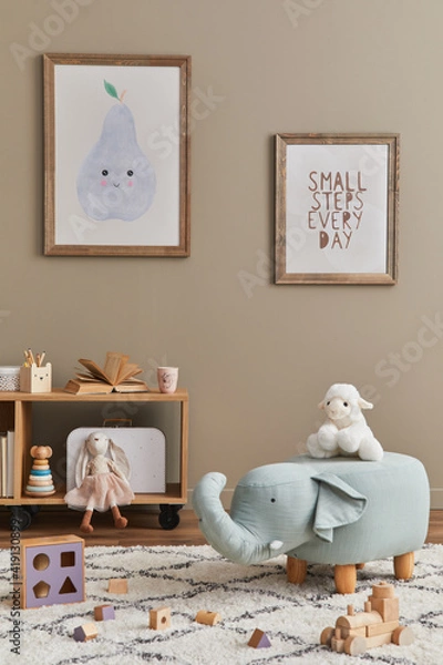 Fototapeta Stylish scandinavian kid room interior with toys, teddy bear, plush animal toys, furniture, decoration and child accessories. Brown wooden mock up poster frames on the wall. Template