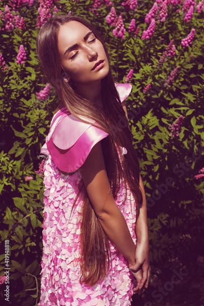 Fototapeta  Sunny woman in pink dress with petals
