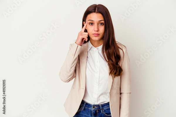 Fototapeta Young Indian business woman isolated on white background pointing temple with finger, thinking, focused on a task.