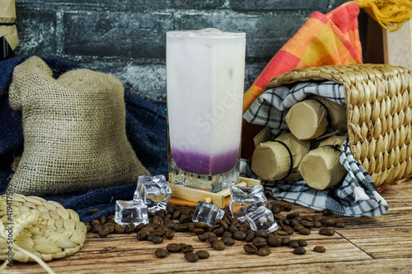 Fototapeta Iced Milkshake Taro is combined taro powder, milk, brewed tea, ice, and creamer. taste is sweetness, smooth, an creamy so is perfect drink on tropical area