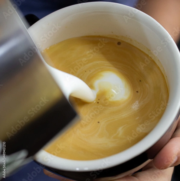 Obraz pouring milk into a cup