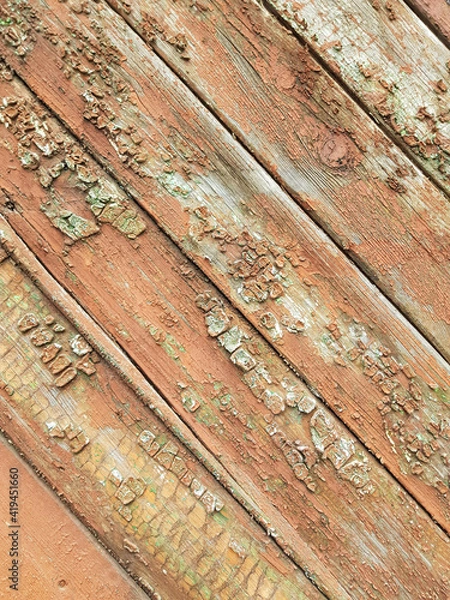 Fototapeta textured background of old time-worn wooden planks, set at an angle of 45 degrees, from a mixture of red, white and brown colors, siding of a wood panel of an old house, close-up, no people, patern. 