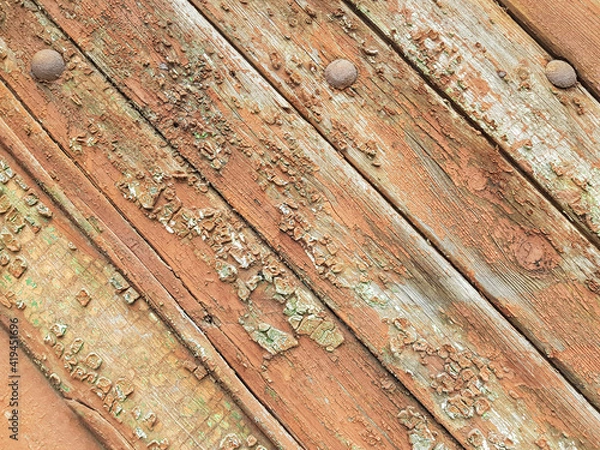Fototapeta textured background of old time-worn wooden planks, set at an angle of 45 degrees, from a mixture of red, white and brown colors, siding of a wood panel of an old house, close-up, no people, patern. 