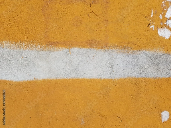 Fototapeta Bright orange wall with white horizontal stripe in the middle, outdoors during the day. Abstract background for text. Warning color, careful, possibly dangerous. Dirty wall with scraps and scratches.