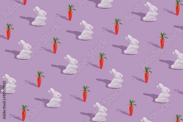 Fototapeta Pattern with white rabbit and orange carrot on violet background.