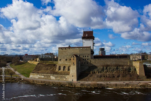 Obraz View of Narva Castle with tall Herman's tower. Warm evening day of February 2020, the city of Narva, Estonia.