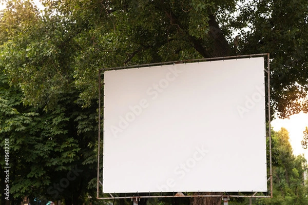 Fototapeta Open air cinema or theater, outdoors movie. Large empty movie screen with copy space