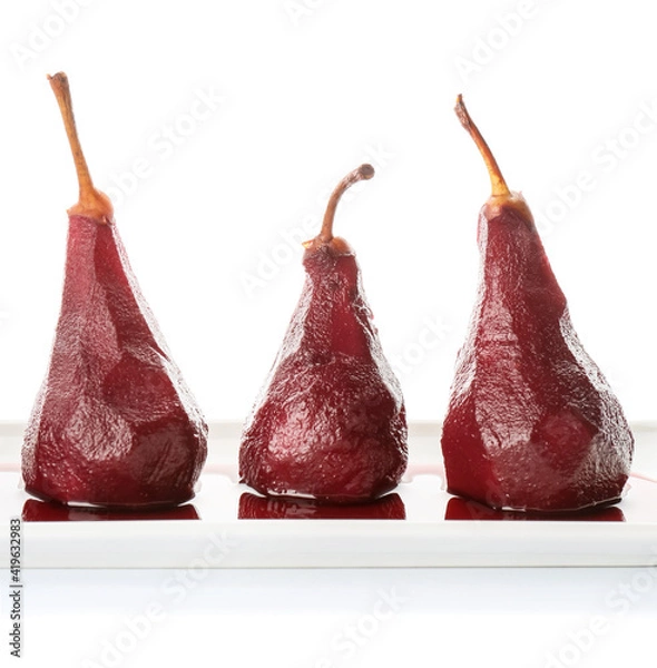 Fototapeta Plate of tasty poached pears in wine sauce on white background