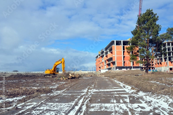 Fototapeta The process of building a multi-storey residential building made of red brick.