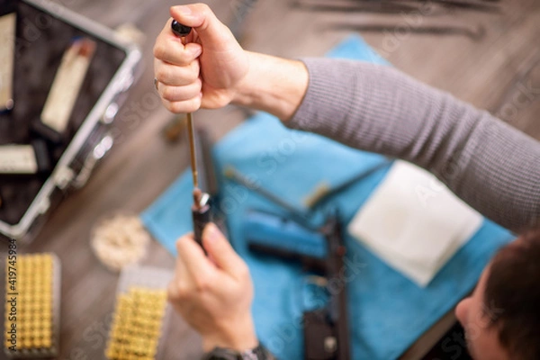 Fototapeta Man cleaning gun