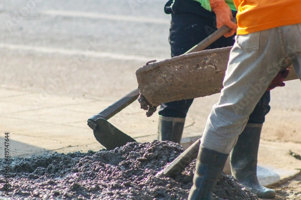 Obraz concrete casting work. using a concrete pump machine to fill the floor concrete with worker.