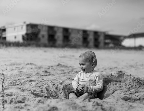 Fototapeta Toddler in Hole in the Sand
