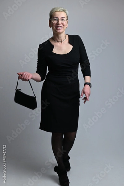 Fototapeta Full length portrait of caucasian woman with handbag on gray background