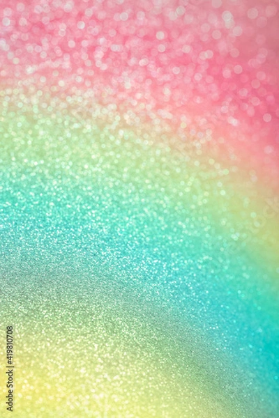Fototapeta Sparkling glitter vertical background. Abstract texture of shiny grainy paper with gradient pink, green and yellow dusting