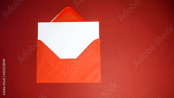Obraz Blank greeting card with red envelope on red background
