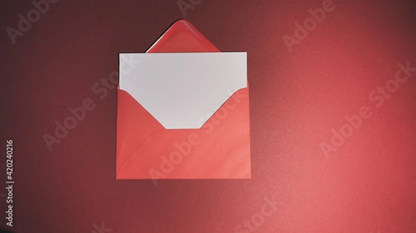 Obraz Blank greeting card with red envelope on red background

