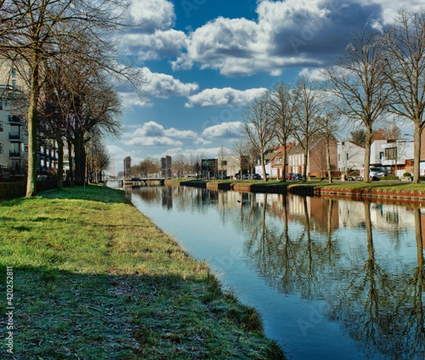 Fototapeta canal the Zuid Willemsvaart in the city Weert the Netherlands with a bridge in the background
