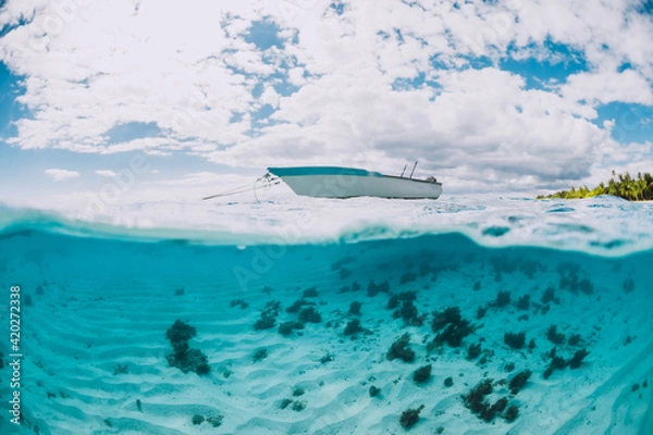 Fototapeta Clear tropical ocean water with sandy bottom and boat
