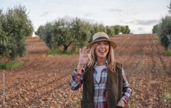 Obraz Happy female field engineer examining in agricultural plantation. Integration of women in the field, agriculture and happy women concepts