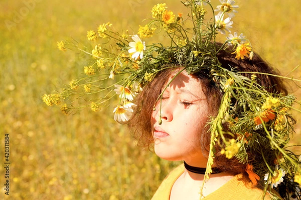 Fototapeta Girl with wreath on head in the field.