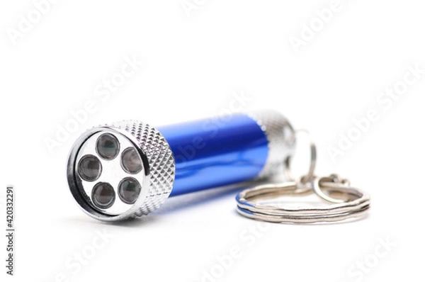 Fototapeta LED flashlight with the ability to recharge from the network on a white background