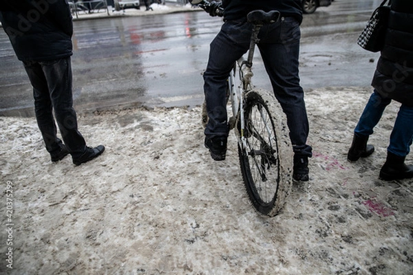 Obraz Slush.Asphalt road covered with melting dirty snow and mud on an early spring day.Road is not cleared of snow.Spring thaw.Snow melting.Large muddy puddle in the middle of the highway.