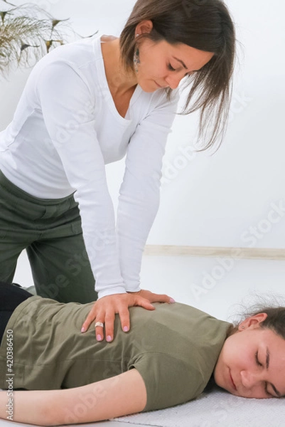 Obraz Teenager getting Shiatsu massage from Shiatsu masseuse