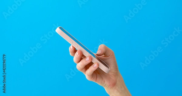 Obraz Close-up phone in hand studio side view