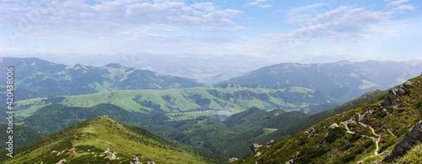 Fototapeta Mountain valley and mountain ranges against the sky with clouds