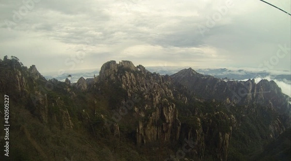 Fototapeta China Mount HuangShan - April, 2015: Natural scenery, sunsets, peculiarly-shaped granite peaks, Huangshan pine trees and views of the clouds from above. Photo taken in Yellow Mountain (UNESCO).