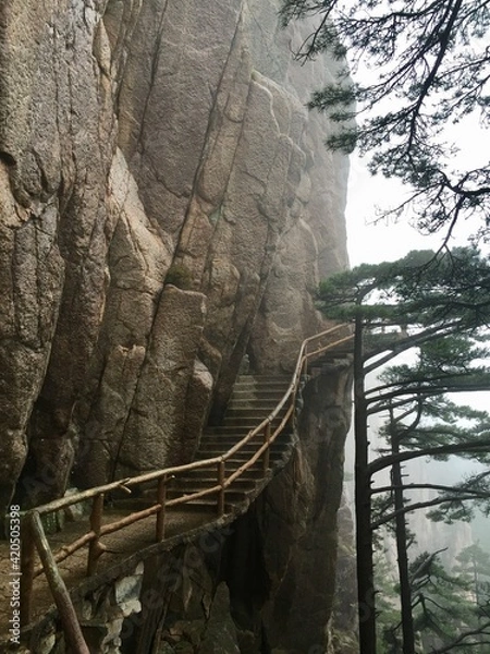 Fototapeta China Mount HuangShan - April, 2015: Natural scenery, sunsets, peculiarly-shaped granite peaks, Huangshan pine trees and views of the clouds from above. Photo taken in Yellow Mountain (UNESCO).