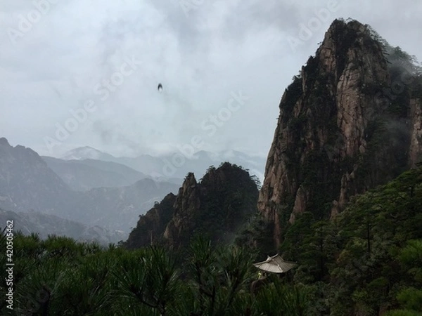Fototapeta China Mount HuangShan - April, 2015: Natural scenery, sunsets, peculiarly-shaped granite peaks, Huangshan pine trees and views of the clouds from above. Photo taken in Yellow Mountain (UNESCO).