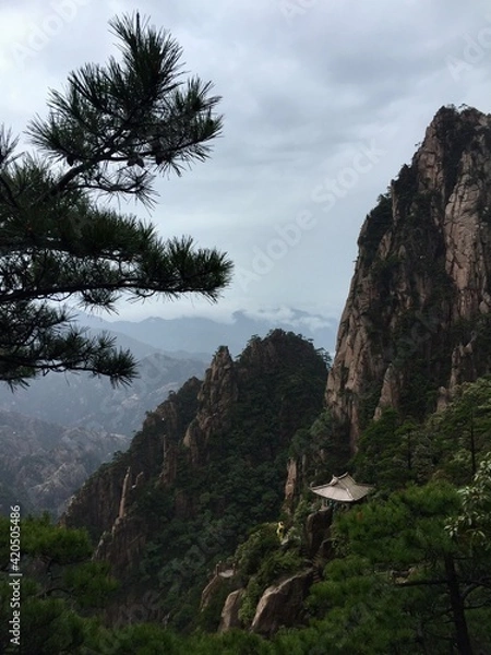 Fototapeta China Mount HuangShan - April, 2015: Natural scenery, sunsets, peculiarly-shaped granite peaks, Huangshan pine trees and views of the clouds from above. Photo taken in Yellow Mountain (UNESCO).
