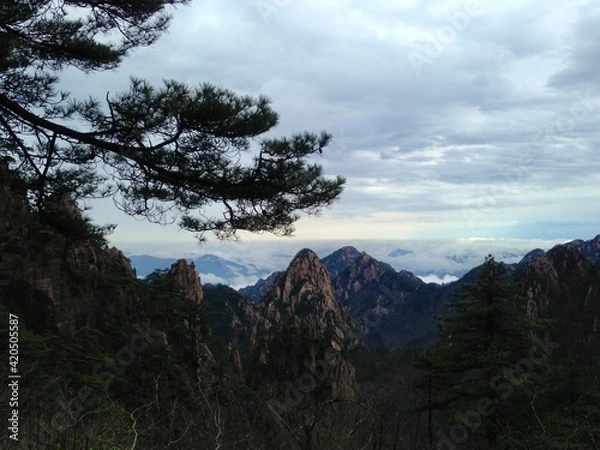 Fototapeta China Mount HuangShan - April, 2015: Natural scenery, sunsets, peculiarly-shaped granite peaks, Huangshan pine trees and views of the clouds from above. Photo taken in Yellow Mountain (UNESCO).