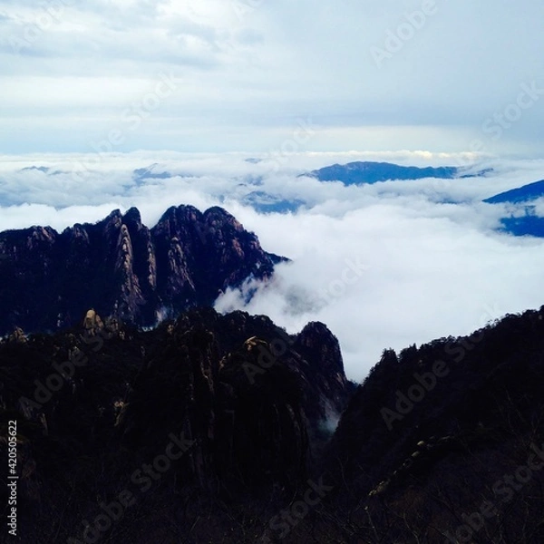 Fototapeta China Mount HuangShan - April, 2015: Natural scenery, sunsets, peculiarly-shaped granite peaks, Huangshan pine trees and views of the clouds from above. Photo taken in Yellow Mountain (UNESCO).