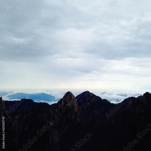 Fototapeta China Mount HuangShan - April, 2015: Natural scenery, sunsets, peculiarly-shaped granite peaks, Huangshan pine trees and views of the clouds from above. Photo taken in Yellow Mountain (UNESCO).