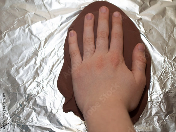 Obraz imprinting a child's hand of a boy on polymer clay.