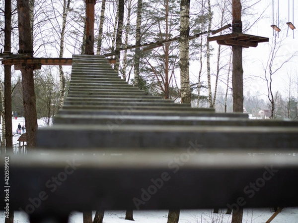 Obraz rope town. a wooden staircase between the trees. steps up
