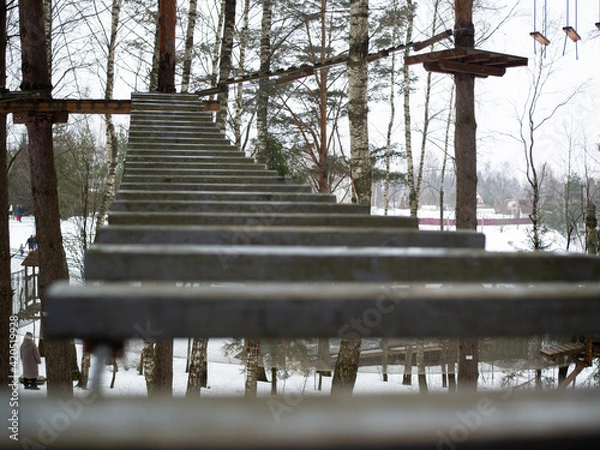 Obraz rope town. a wooden staircase between the trees. steps up