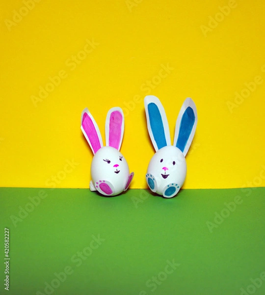Fototapeta Easter bunnies from an egg on a yellow background.