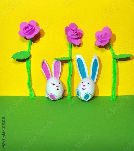 Fototapeta Easter bunnies from an egg on a yellow background.
