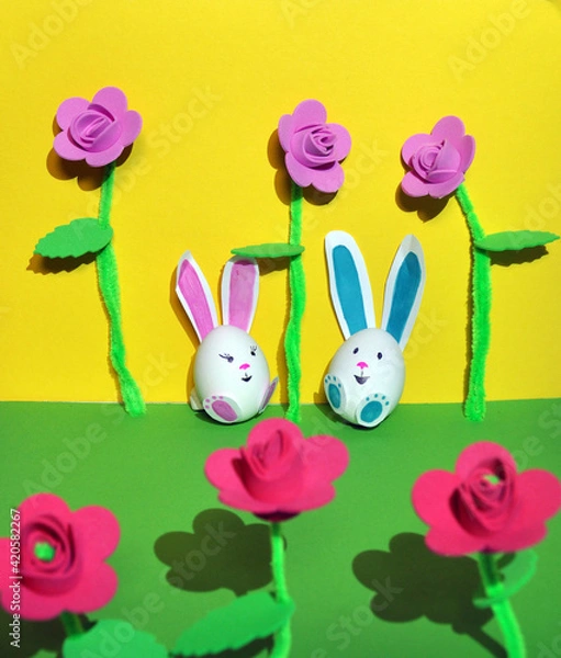 Fototapeta Easter bunnies from an egg on a yellow background.