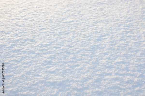 Fototapeta Fresh clean white snow background texture. Winter background with frozen snowflakes and snow mounds. Snow lumps. Seasonal landscape details. Cold weather.