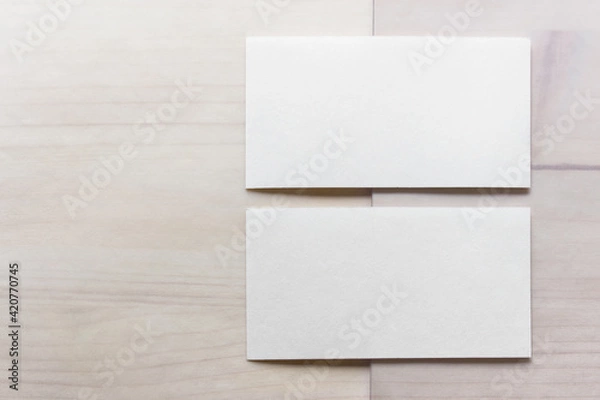 Fototapeta Mockup template with two blank business cards on wooden background.