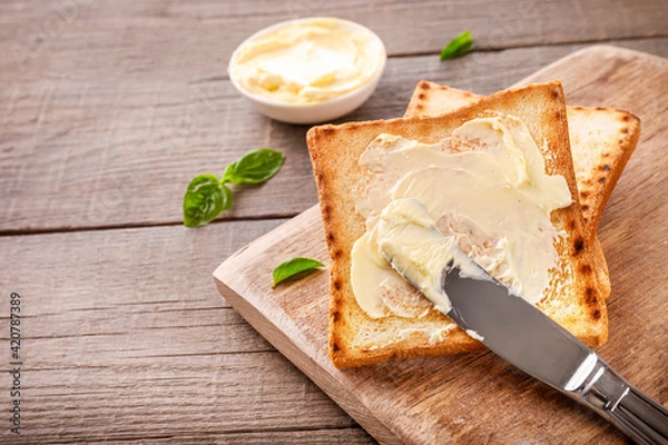 Fototapeta Slices of toast bread with butter